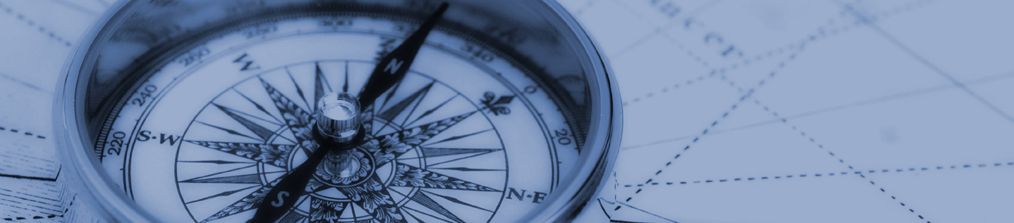 People looking at printed spreadsheets on a table