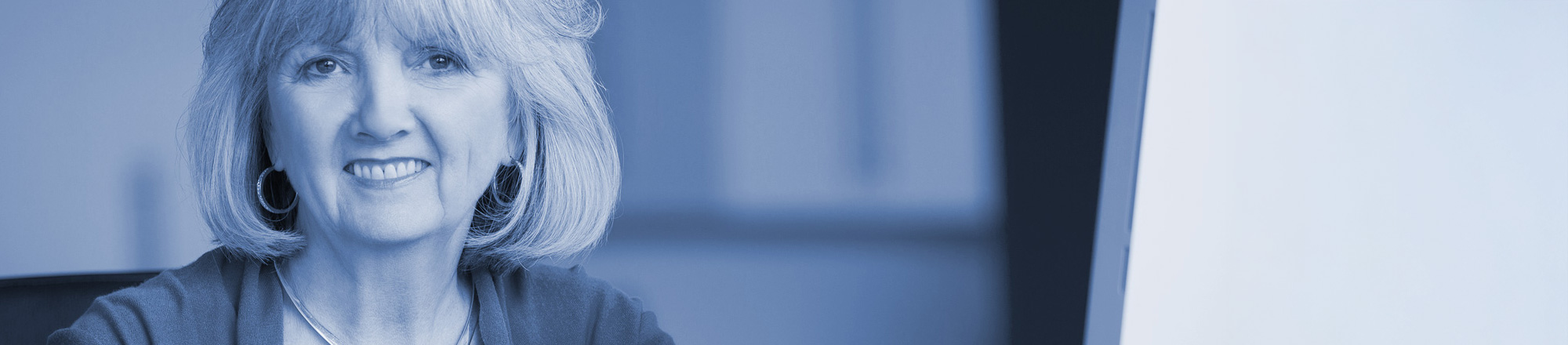 People looking at printed spreadsheets on a table